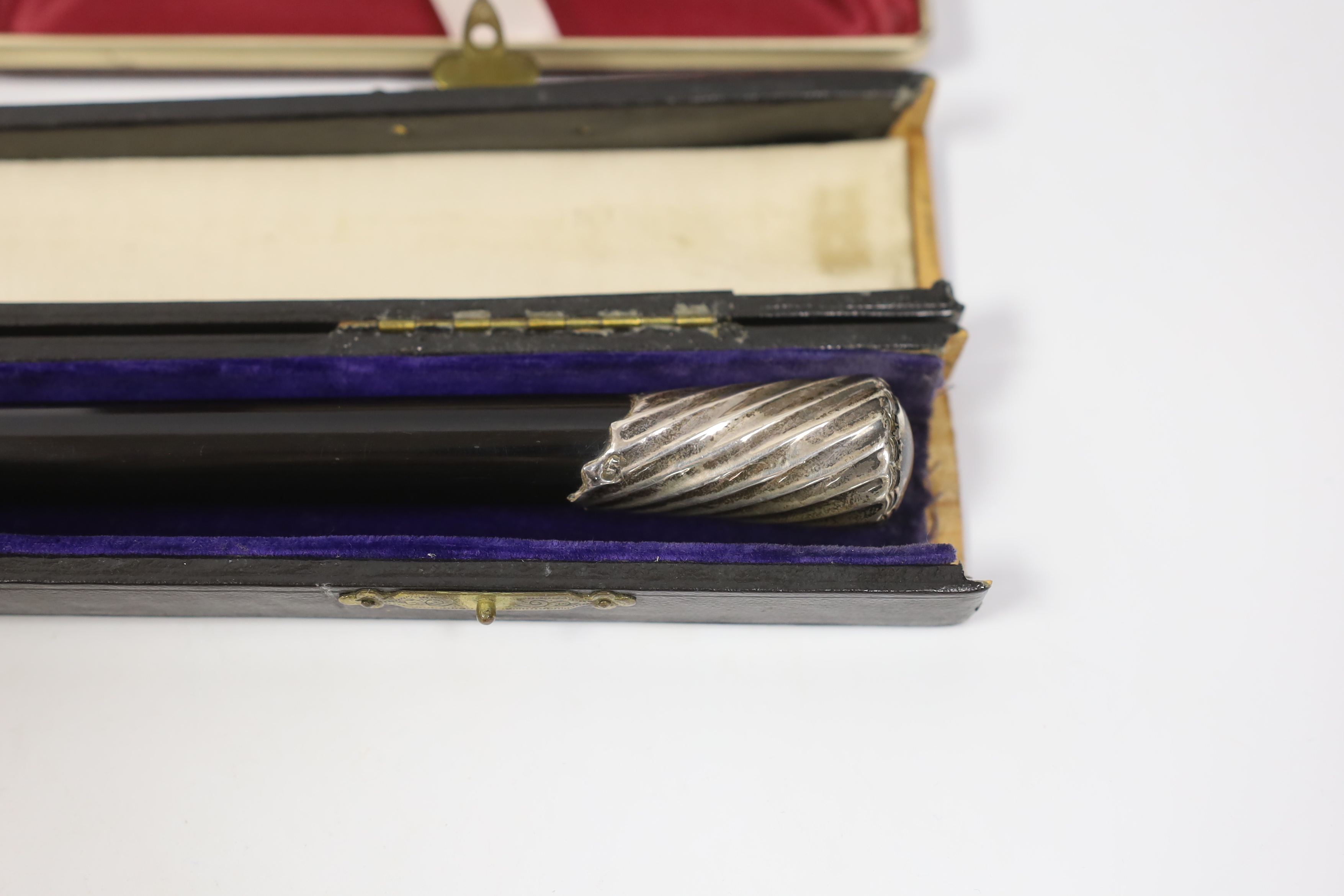 An Elizabeth II silver mounted rectangular cigarette box, Birmingham, 1963, 17.4cm, a cased 1920's silver mounted ebonised conductor's baton, 52.5cm, a pair of silver sugar tongs and a small silver spoon.